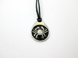 Cancer horoscope pendant necklace, teardrop pendant with black background, on black cord, for man r woman. (photo taken on a white background)