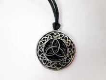 Load image into Gallery viewer, Celtic trinity knot pendant necklace, round pendant with black background, on black cord, for unisex teen or adult . (Photo taken on a white background)
