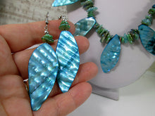 Load image into Gallery viewer, closeup view of teal shell earrings