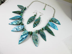 side view of teal shell leaf necklace and earrings set