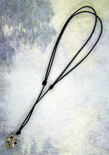 Load image into Gallery viewer, full view of Artist palette pendant necklace on black cord, with painted paint sports, for unisex teen or adult. (photo taken on a marble background)