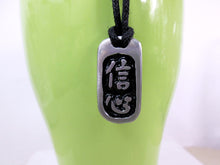 Load image into Gallery viewer, Kanji symbol for Confidence pendant with black background, black cord necklace style.