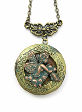 Load image into Gallery viewer, Victorian cherub locket necklace with verdigris patina finish, close-up.