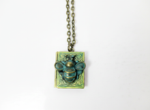 Load image into Gallery viewer, Antique bronze bee book locket necklace with verdigris patina