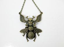 Load image into Gallery viewer, Antique bronze skull bee necklace with wings and crossed bones.