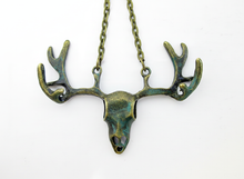 Load image into Gallery viewer, Bronze-toned metal deer skull pendant necklace with antlers on a matching chain, shown against a plain white background.