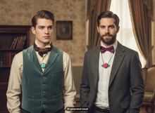 Load image into Gallery viewer, Two men in vintage-style formal wear standing indoors. The man on the left wears a teal vest over a cream shirt with a dark brown bow tie and a antique bronze rose filigree pendant necklace in mint-green resin.  The man on the right wears a grey suit over a white shirt with a burgundy bow tie and a antique  bronze rose filigree pendant necklace in pink resin.