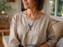 Load image into Gallery viewer, A woman wearing a beige blouse and a vintage bronze hummingbird necklace, seated in a softly lit indoor setting.  A small 'AI-generated visual' label appears at the bottom.