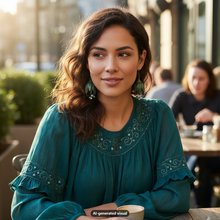 Load image into Gallery viewer, A woman seated at an outdoor cafe with a blurred real-world background, wearing a teal embroidered blouse and a pair of matching vintage brass tulip dangle earrings with glass pearls.  A  small 'AI-generated visual' label appears at the bottom.