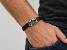 Load image into Gallery viewer, Close-up of the Traveler's Protection Celtic Nehalennia Goddess Bracelet on a wrist, highlighting the hand‑cast pewter centerpiece and dark brown leather band.   small label "AI-generated visual" appears  t the bottom of the photo.