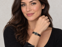 Load image into Gallery viewer, Female model showcasing the Traveler's Protection Celtic Nehalennia Goddess Bracelet with its hand‑cast pewter centerpiece, worn with a black sweater against a light gray background.  A small "AI-generated visual" label appears at the bottom of the photo.