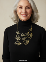 Load image into Gallery viewer, A smiling older woman with gray hair wears a black turtleneck sweater and a antique bronze flock of sparrows necklace, against a plain beige studio background. A small 'AI-generated visual' watermark appears at the bottom.