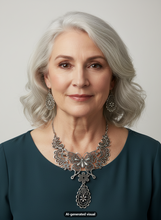 Load image into Gallery viewer, A close-up portrait of a woman with silver-gray hair wearing a large ornate silver filigree butterfly necklace and matching drop earrings, paired with a dark teal top against a light gray background. A small 'AI-generated visual' label appears at the bottom.