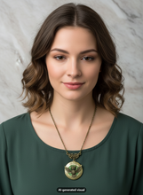 Load image into Gallery viewer, A woman with wavy brown hair wearing a dark green top and a bronze owl locket necklace with a triangular filigree connector, set against a light gray marble background.  A small "AI-generated visual" label appears at the bottom.