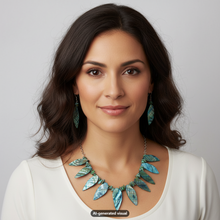 Load image into Gallery viewer, A woman with dark brown hair wearing a teal iridescent (turquoise and blue marbled) mother of pearl leaf-shaped necklace and matching shell leaf drop earrings, styled with a white top against a light gray.  A small 'AI-generated visual' label is visible at the bottom.