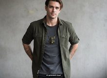 Load image into Gallery viewer, A man wearing an olive green button-up shirt over a dark gray t-shirt, accessorized with a antique bronze skull bee pendant necklace with wings and crossbones, standing against a textured gray wall.  A small "AI-generated visual" label is at the bottom.