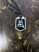 Load image into Gallery viewer, close-up front view of handmade pewter paddler pendant necklace, pendant with black background, on black cord, for men or women (photo of necklace taken on a brown with golden sprinkle background)