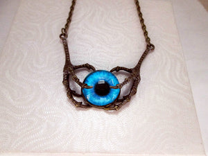 dragon claws with a glow in the dark eye necklace
