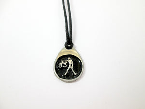 Libra pendant necklace on black cord, teardrop pendant with black background, for man or woman. (picture taken on a white background)