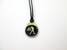 Load image into Gallery viewer, Libra horoscope pendant necklace on black cord, teardrop pendant with black background, for man or woman. (photo taken on a white background)