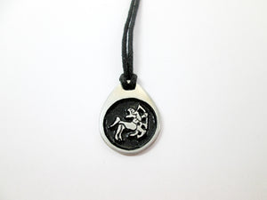 Sagittarius horoscope pendant necklace on black cord, teardrop pendant with black background, for man or woman. (picture taken on a white background)