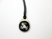 Load image into Gallery viewer, Capricorn pendant necklace on black cord, teardrop pendant with black background, for man or woman. (picture taken on a white background)