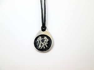 Gemini horoscope pendant necklace on black cord, teardrop pendant with black background, for man or woman (picture taken on a white background)