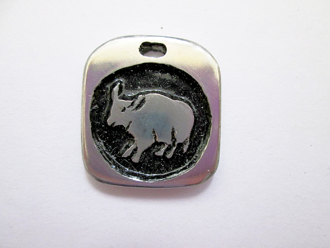 Year of the ox Chinese zodiac pendant with black background. (picture taken on a white background)