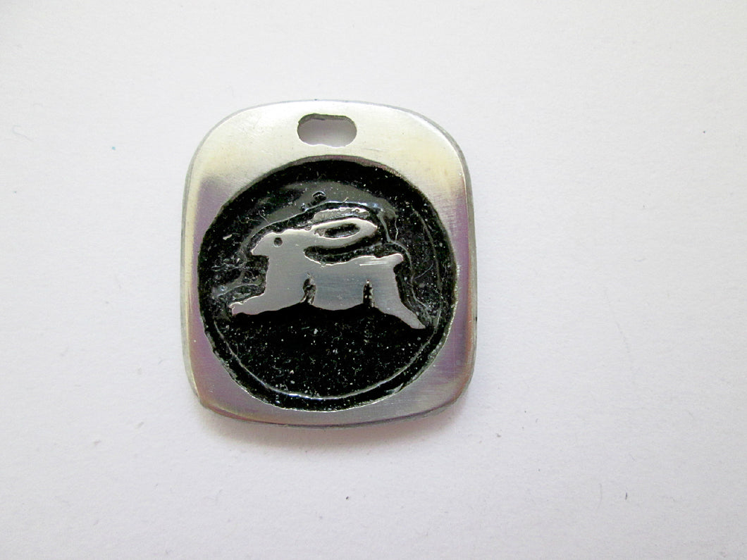 Year of the rabbit or bunny Chinese zodiac pendant with black background. (picture taken on a white background)