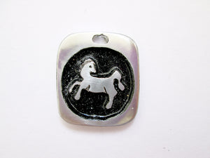 Year of the horse Chinese zodiac pendant with black background (picture taken on a white background