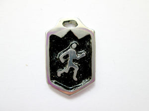 close-up front view of handmade pewter runner or jogger pendant, pendant with black background.