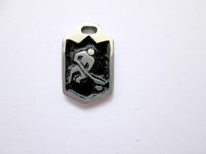 handmade ice or field hockey player pendant with black background.