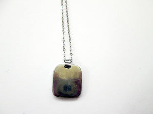 back view of zodiac animal pendant on metal chain, pendant polished with mirror finish.