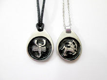 Load image into Gallery viewer, sample of Scopio pendant on black cord and Sagittarius pendant on metal chain. (picture taken on a white background). for man or woman.