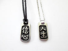 Load image into Gallery viewer, samples of Chinese symbol pendant necklace with black background, rectangular shape. From left to right;  symbol of confidence pendant necklace on black cord and Chinese symbol of Life pendant necklace on metal chain. and metal chain necklace