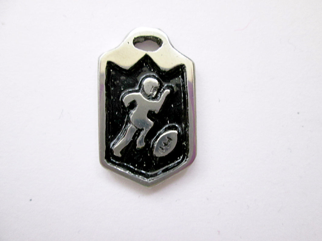 handmade pewter football player pendant, pendant with black background.