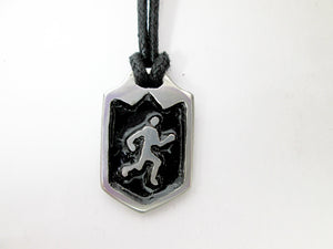 close-up view of handmade pewter runner or jogger pendant necklace, pendant with black background, on black cord, for men or women.