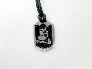 close-up front view of handmade pewter paddler pendant necklace, pendant with black background, on black cord, for men or women