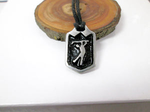 handmade pewter golf player pendant necklace, pendant with black background, on black cord, for man or woman. (photo taken on a background with a piece of wood)