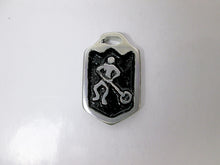Load image into Gallery viewer, close up view of handmade pewter ringette player pendant with black background, for men or women.