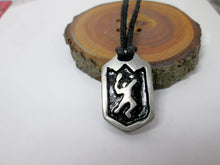 Load image into Gallery viewer, handmade pewter tennis player pendant necklace, pendant with black background, on black cord, for men or women (photo of necklace taken on a background with a piece of wood)