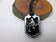 Load image into Gallery viewer, curling player pendant necklace, pendant with black background, on black cord. for unisex teen or adult. (photo taken on a background with a piece of wood)