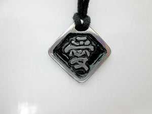 Kanji symbol for Love pendant with black background, black cord necklace style.