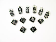 Load image into Gallery viewer, a display of good vibes Chinese symbol pendants with black background.  Top row from left to right; symbol of Confidence. creative, dream or goal, harmony, serenity, success. Midle row from left to right; symbol of faith or belief, good luck, courage and bravery, strength.  Boton row from left to right; symbol of love, love. 