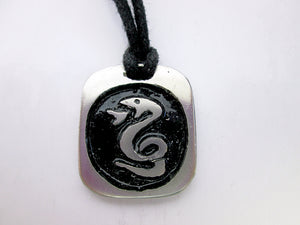 Year of the snake necklace, for unisex, squarish pendant with black background, cotton cord style. (picture taken on a white background)