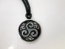 Load image into Gallery viewer, Celtic triskele pendant necklace, round pendant with black background,  on black cord, for unisex teen or adult. (photo taken on a white background) 