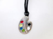 Load image into Gallery viewer, Artist palette pendant necklace on black cord, with painted paint sports, for unisex teen or adult. (photo taken on a white background).