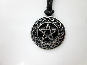 Celtic pentacle pendant necklace, round pendant with black background, on black cord, for unisex teen or adult. (photo taken on a white background)