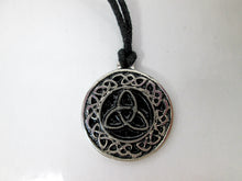 Load image into Gallery viewer, Celtic trinity knot pendant necklace, round pendant with black background, on black cord, for unisex teen or adult . (Photo taken on a white background)