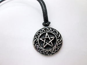 close up front view of Celtic pentacle pendant necklace, round pendant with black background, on black cord, for unisex teen or adult. (photo taken on a white background)